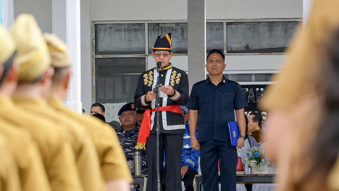 Walikota Bitung Hengky Honandar, S.E., saat menyampaikan pidato menteri mengenai pentingnya peran ayah mengasuh anak pada Upacara Harganas ke-33 di Lapangan Kantor Walikota, Senin (29/6/2026). (Foto: Istimewa)
